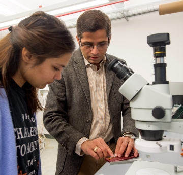 Professor showing student lab