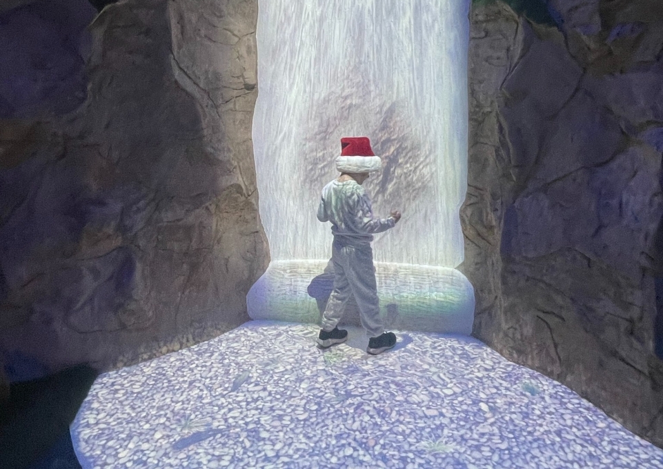 Child using interactive waterfall